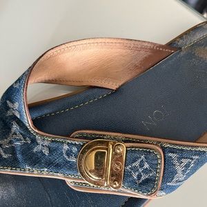 Louis Vuitton monogram denim slide sandals with decorative signature v-lock.